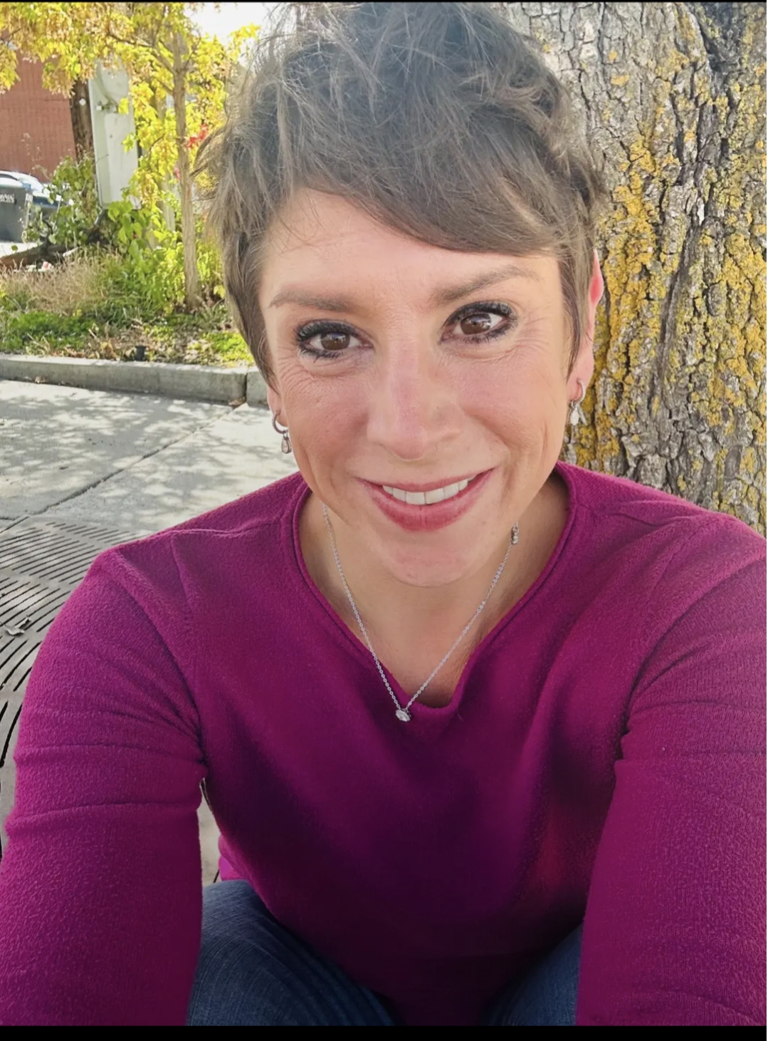 Detail shot of hands tending to a small plant, connoting growth and care.